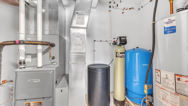 utility room with heating unit and gas water heater