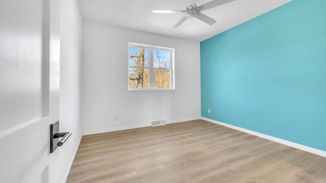 spare room with light hardwood / wood-style flooring and ceiling fan