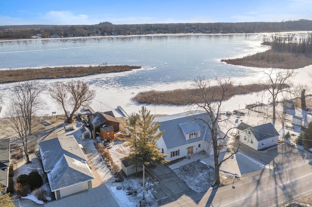 snowy aerial view with a water view