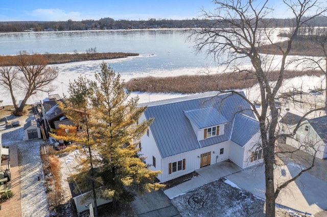 snowy aerial view with a water view