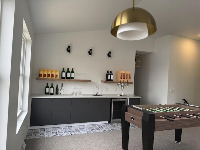 recreation room featuring a healthy amount of sunlight, light colored carpet, beverage cooler, and wet bar