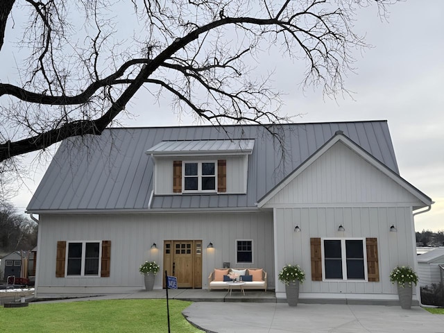 rear view of property featuring a lawn