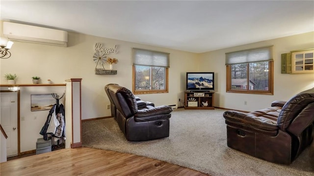 living room with hardwood / wood-style flooring and an AC wall unit