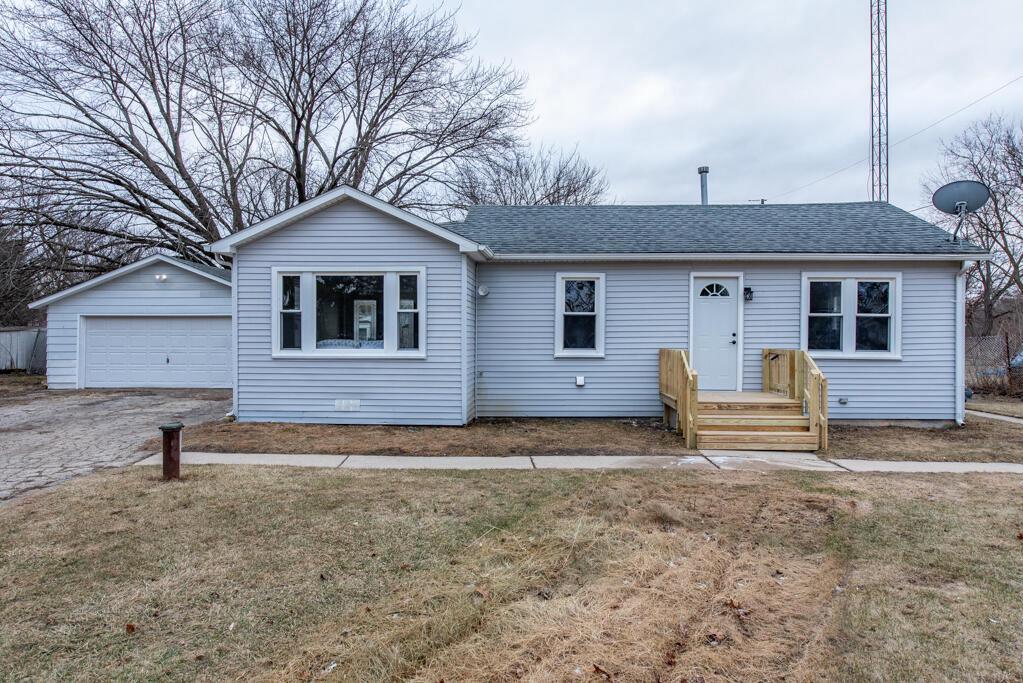 ranch-style home with a garage and a front yard