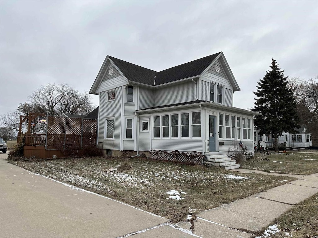 view of front facade with a sunroom