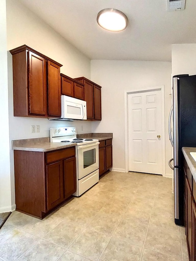 kitchen featuring white appliances and light tile patterned floors