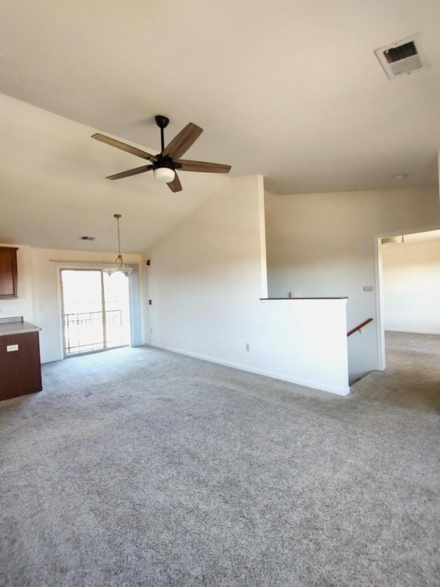 unfurnished living room with carpet, ceiling fan, and vaulted ceiling