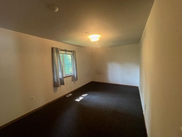 empty room featuring a textured ceiling