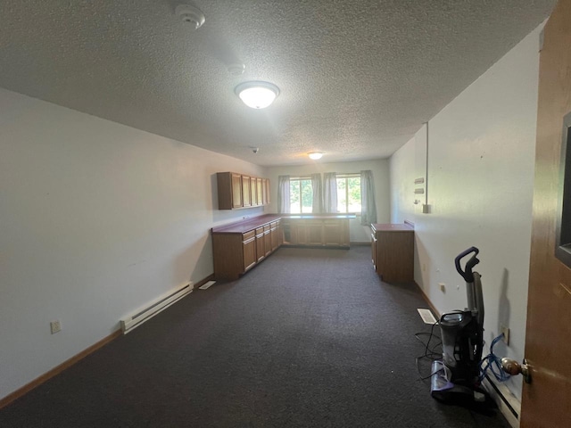 spare room with a textured ceiling and a baseboard radiator