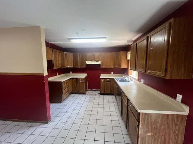 kitchen with light tile patterned flooring, black dishwasher, and sink