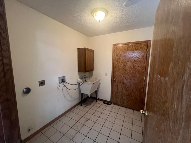 laundry area featuring washer hookup, electric dryer hookup, cabinets, and a textured ceiling