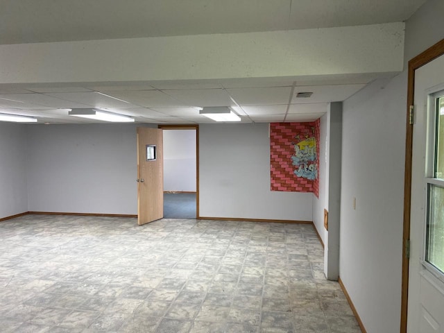 unfurnished room featuring a drop ceiling