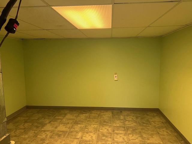 empty room featuring a paneled ceiling