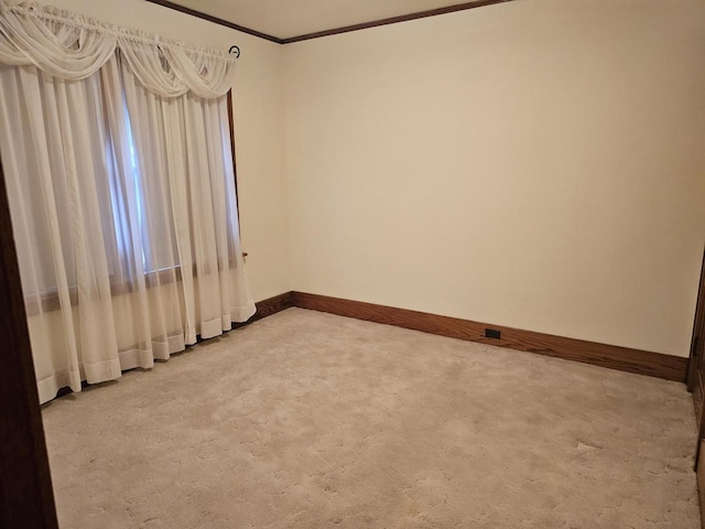 unfurnished room with carpet floors and ornamental molding