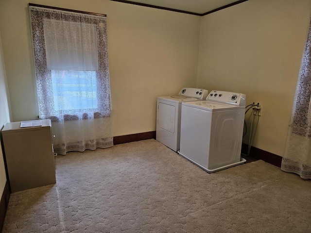 laundry area with washer and clothes dryer, light colored carpet, and ornamental molding