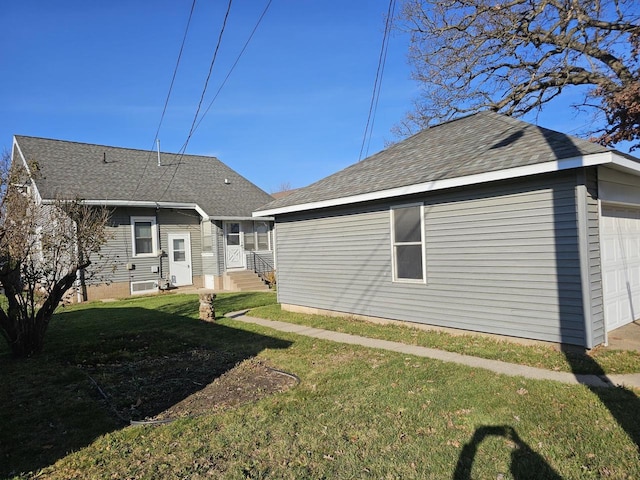 rear view of house featuring a yard