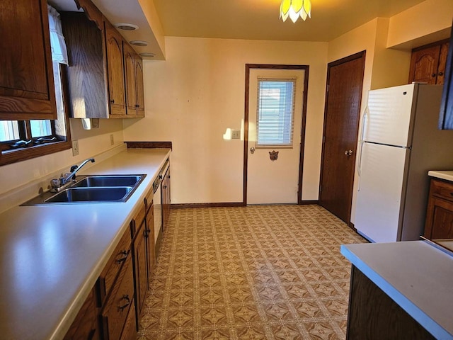 kitchen featuring white fridge and sink