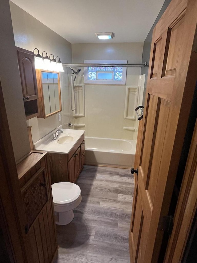 full bathroom featuring shower / bathtub combination, wood-type flooring, toilet, and vanity