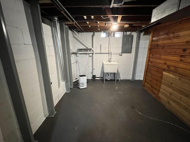 basement with sink and electric panel