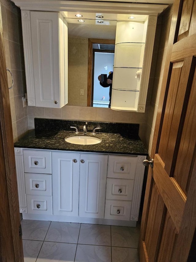 bathroom featuring tile patterned flooring and vanity