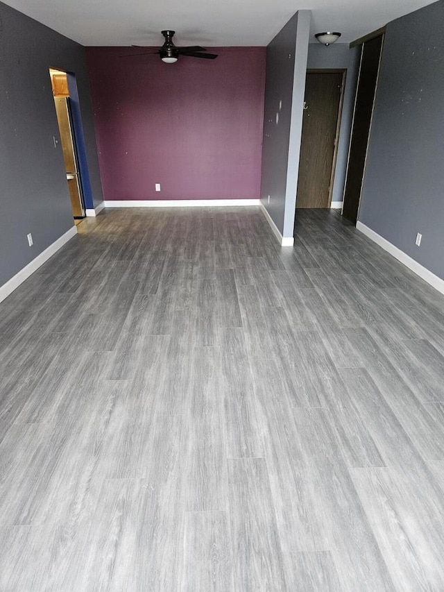 empty room featuring ceiling fan and hardwood / wood-style floors