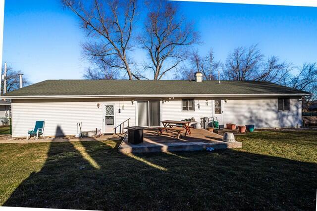 back of house with a lawn and a patio