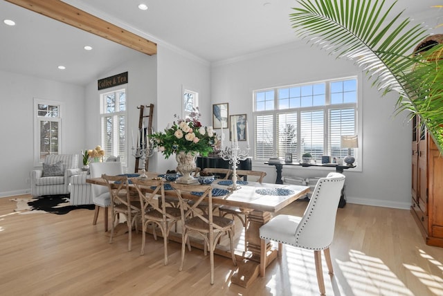 dining room with beamed ceiling, light hardwood / wood-style floors, and ornamental molding