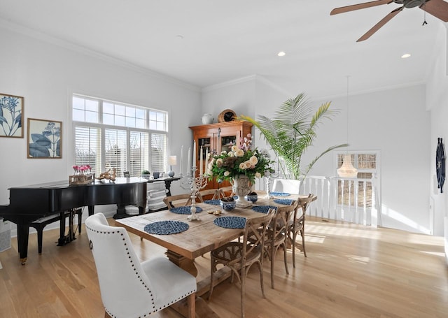 dining area with crown molding, ceiling fan, and light hardwood / wood-style floors