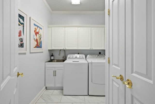 clothes washing area with crown molding, cabinets, separate washer and dryer, and sink