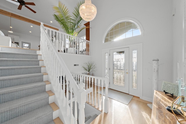 entrance foyer with a high ceiling, light hardwood / wood-style flooring, and ceiling fan