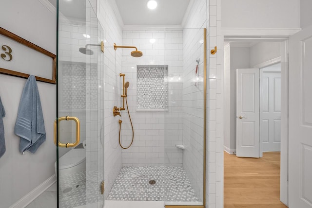 bathroom featuring hardwood / wood-style floors and walk in shower