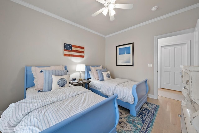 bedroom featuring ceiling fan, ornamental molding, and light wood-type flooring