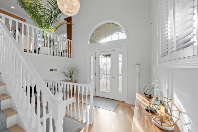 entryway featuring a high ceiling and hardwood / wood-style flooring