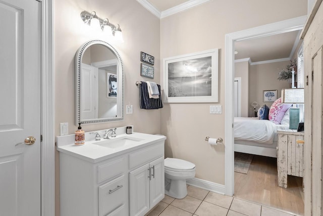 bathroom featuring tile patterned flooring, vanity, toilet, and crown molding