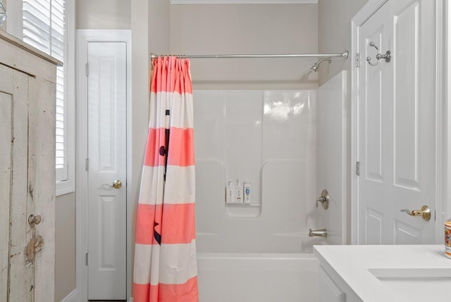 bathroom featuring a healthy amount of sunlight and shower / tub combo with curtain