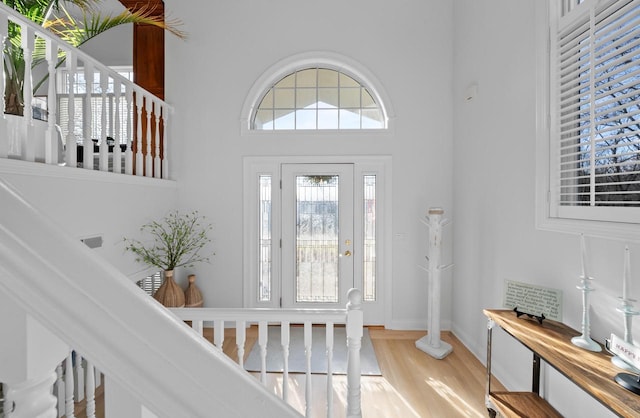 entryway featuring hardwood / wood-style floors and a high ceiling