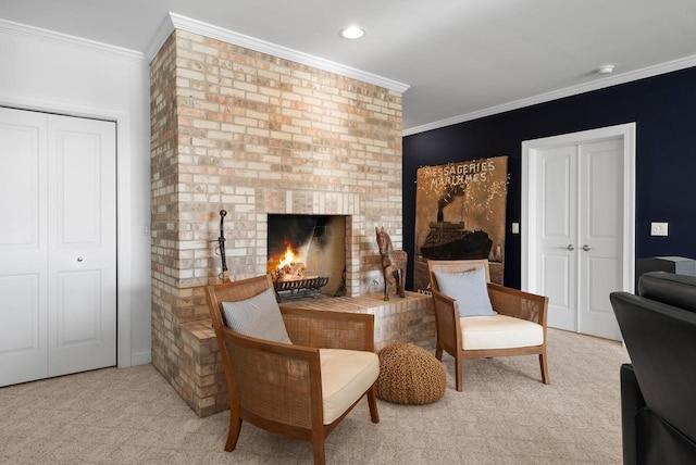 sitting room featuring a brick fireplace, light colored carpet, and ornamental molding