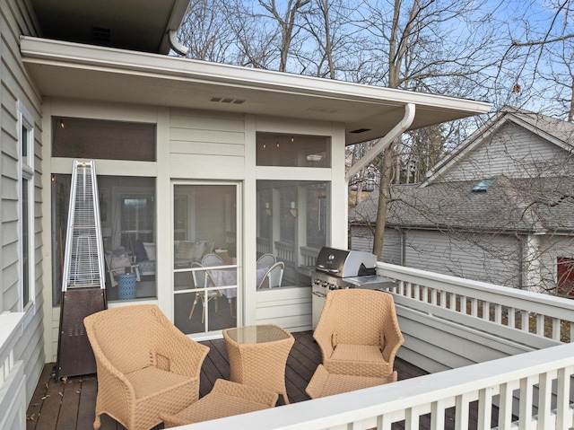 deck featuring a sunroom and grilling area