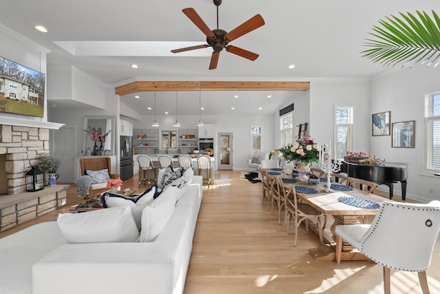 living room with ceiling fan, light hardwood / wood-style floors, crown molding, and a fireplace