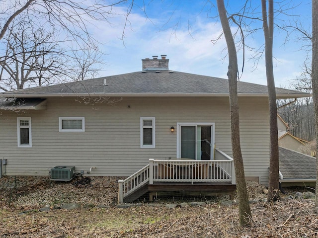 rear view of house featuring central AC unit and a deck