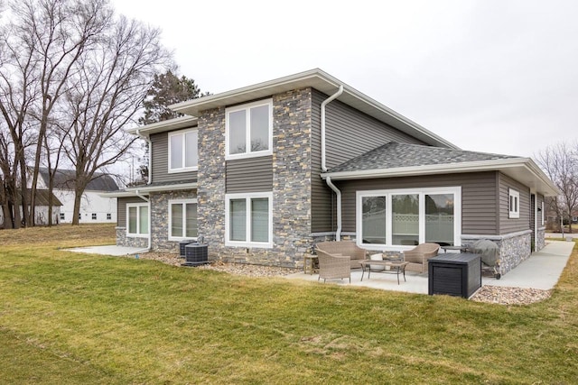 back of property with a patio area, an outdoor hangout area, and a yard