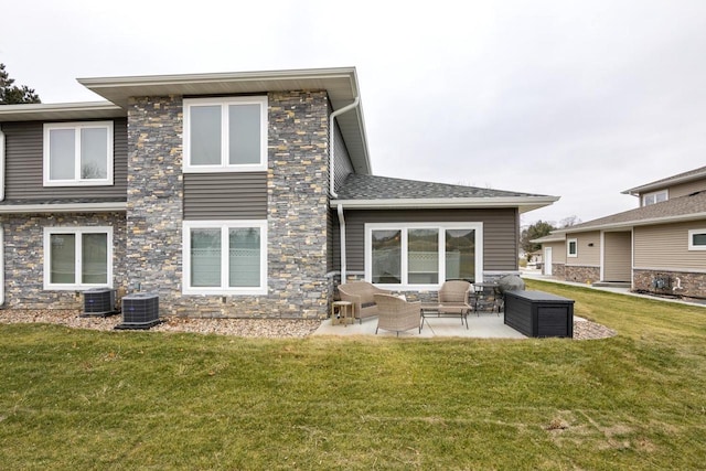 back of house featuring outdoor lounge area, a yard, cooling unit, and a patio