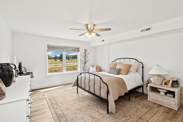 bedroom featuring light hardwood / wood-style floors and ceiling fan