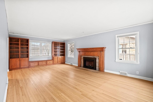 unfurnished living room featuring light hardwood / wood-style floors and ornamental molding