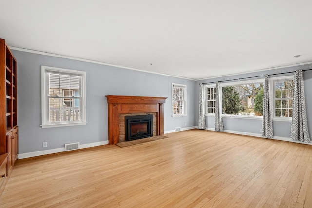 unfurnished living room featuring light hardwood / wood-style floors and ornamental molding