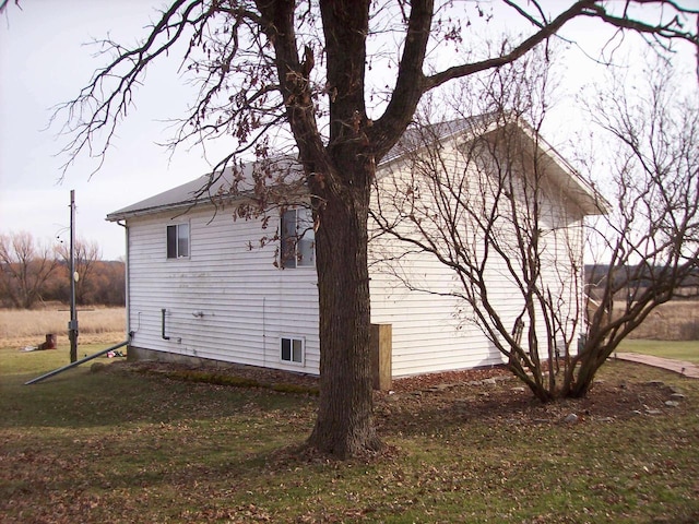 view of side of property with a yard