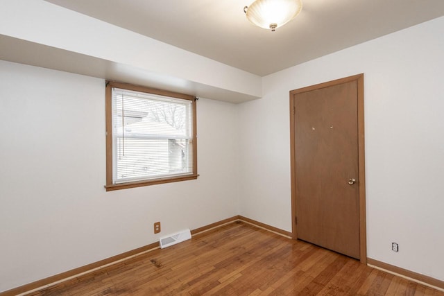 unfurnished room with light hardwood / wood-style flooring