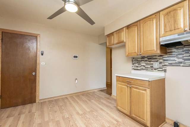 kitchen with decorative backsplash, ceiling fan, exhaust hood, and light hardwood / wood-style flooring