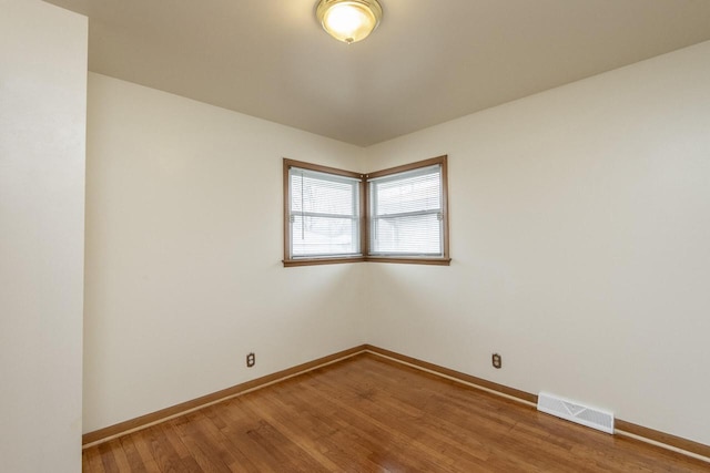 empty room with wood-type flooring