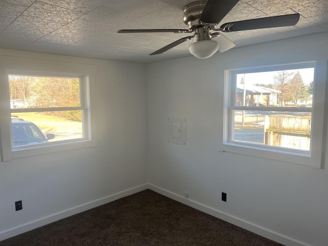 spare room featuring carpet and ceiling fan